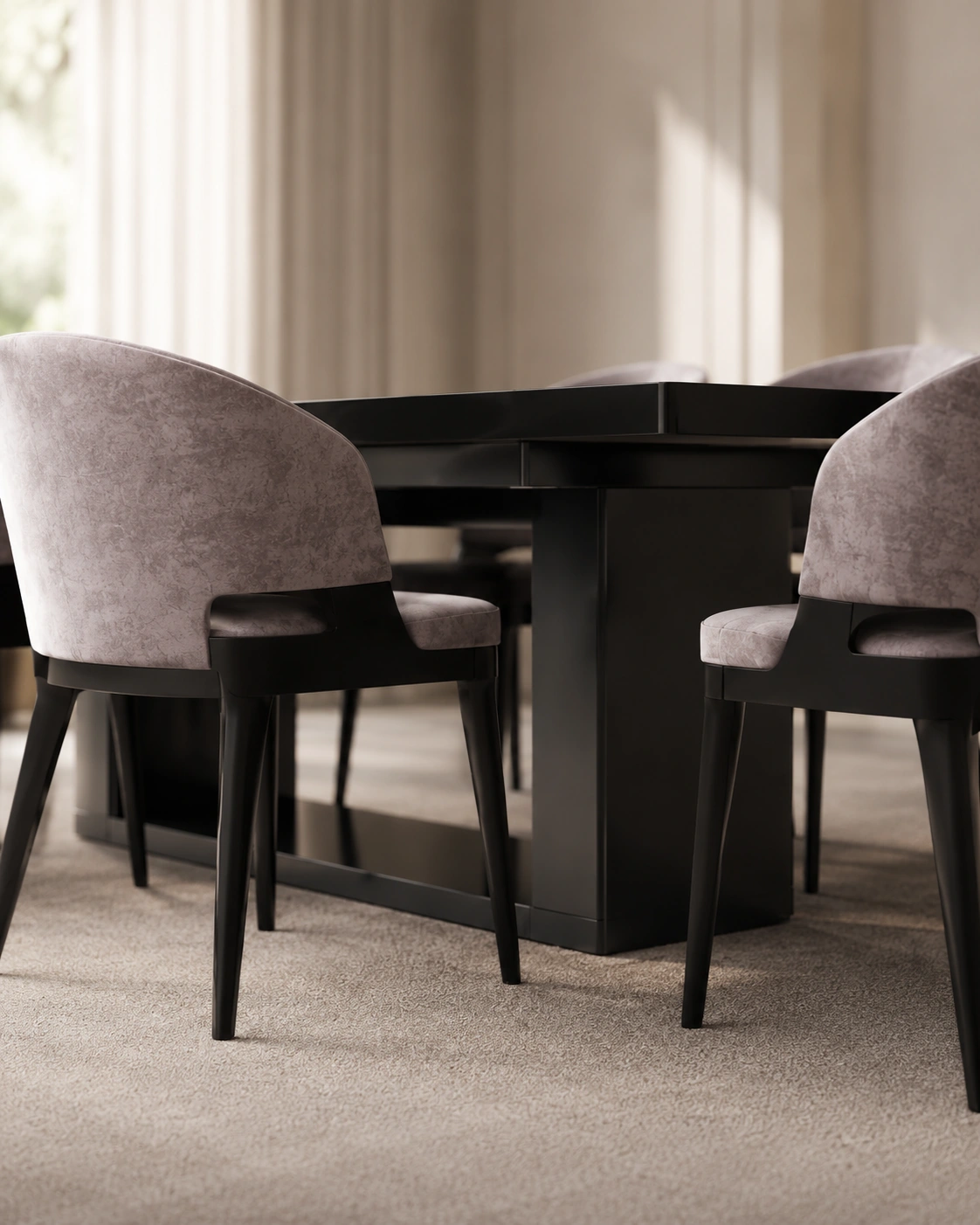Close view of a black dining table and taupe upholstered chairs