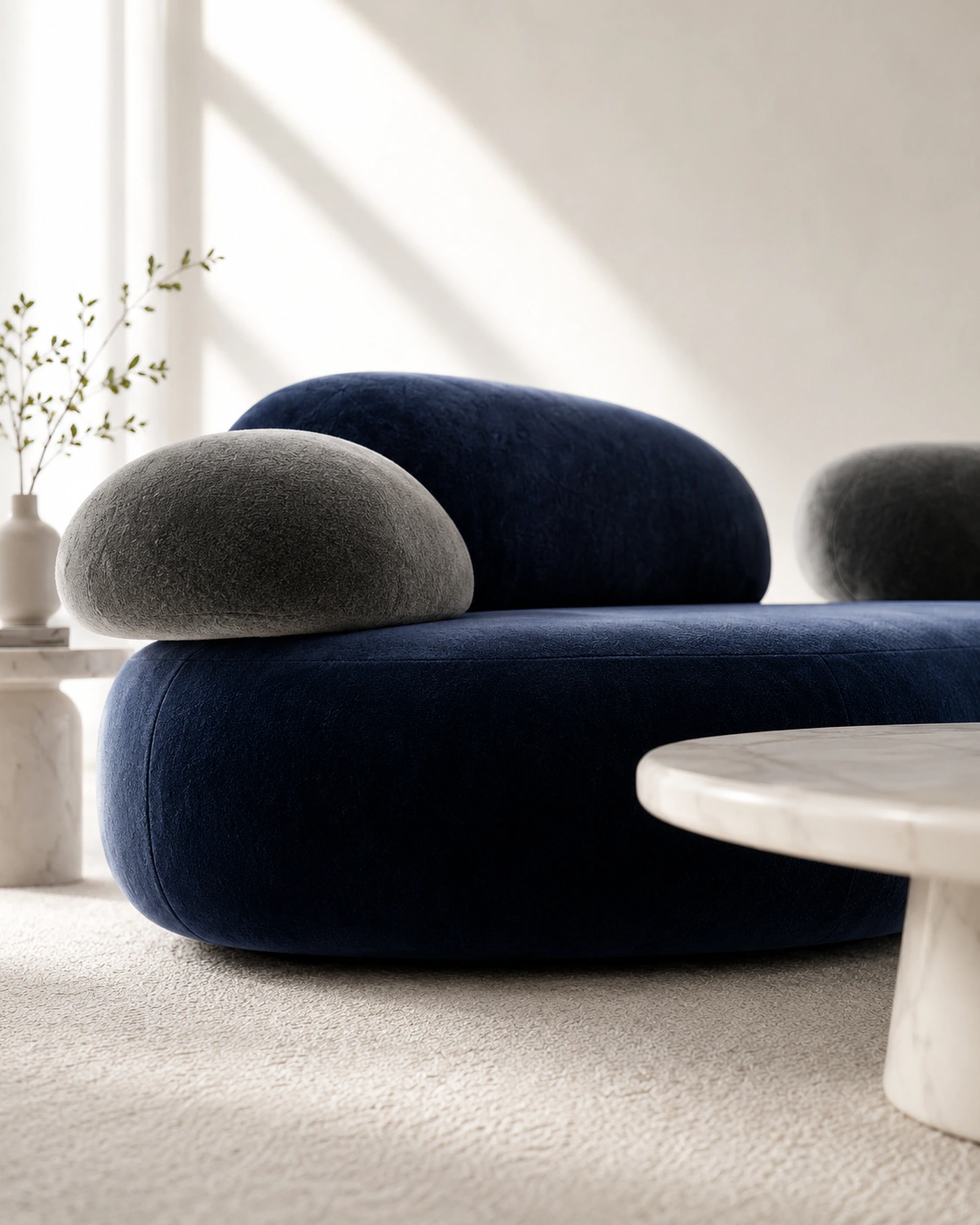 Low-angle view of navy and charcoal sculptural velvet seating