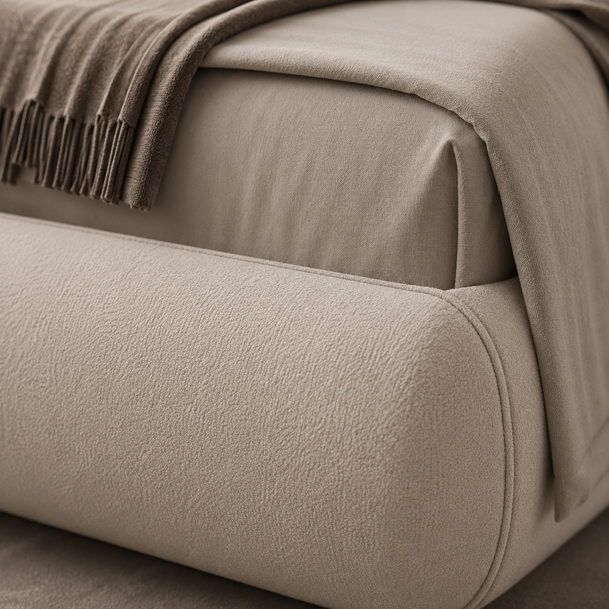 Close detail of the curved bed frame and neutral bedding