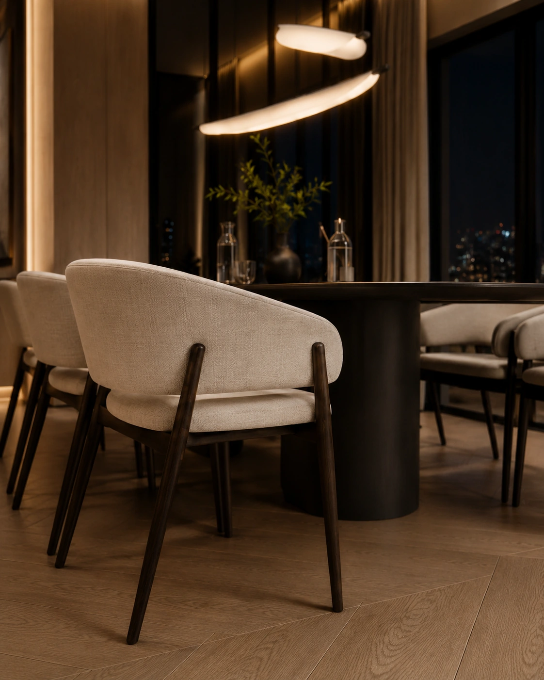 Close view of a dark walnut dining table and ivory upholstered chair