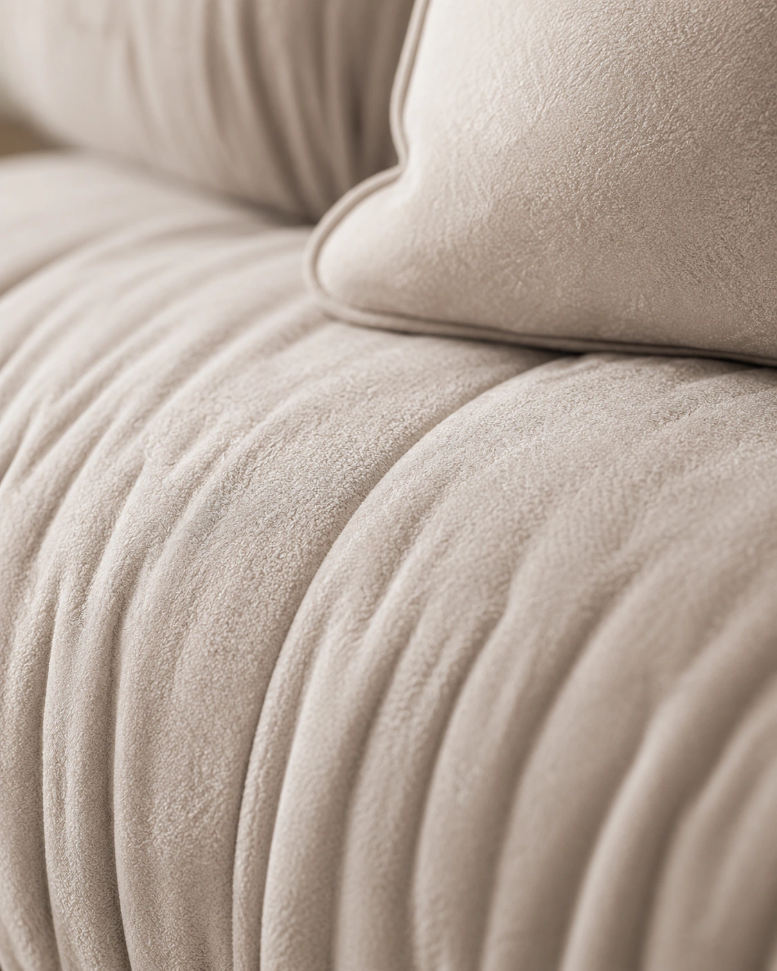 Macro detail of softly gathered ivory upholstery