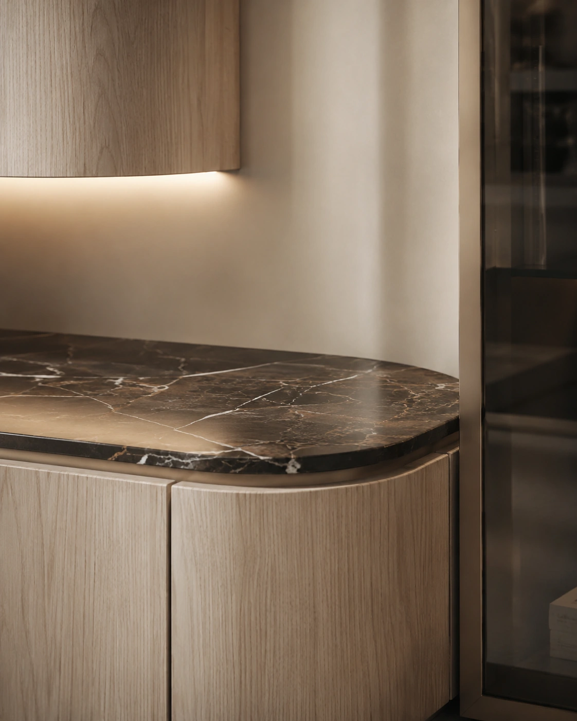 Close detail of rounded oak cabinetry and a dark stone ledge
